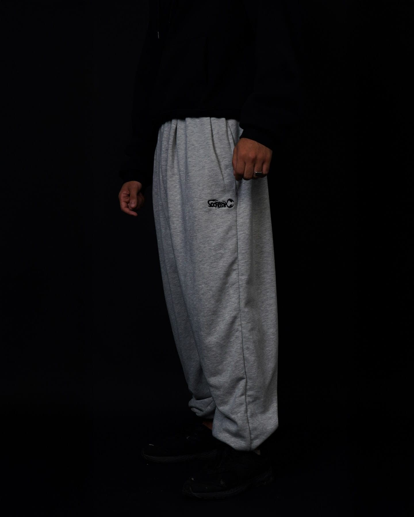 Grey Toji Sweatpants with a black hoodie, side view