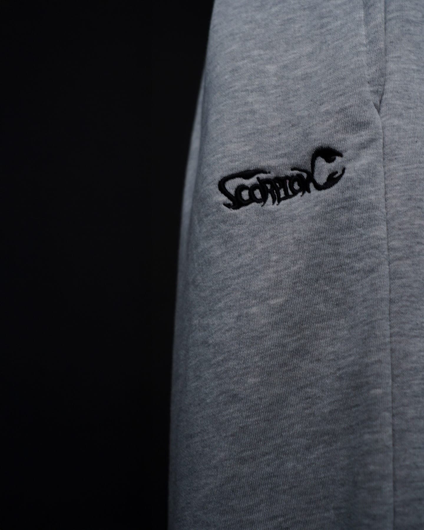 Close-up of the ScorpionX wordmark on grey fleece