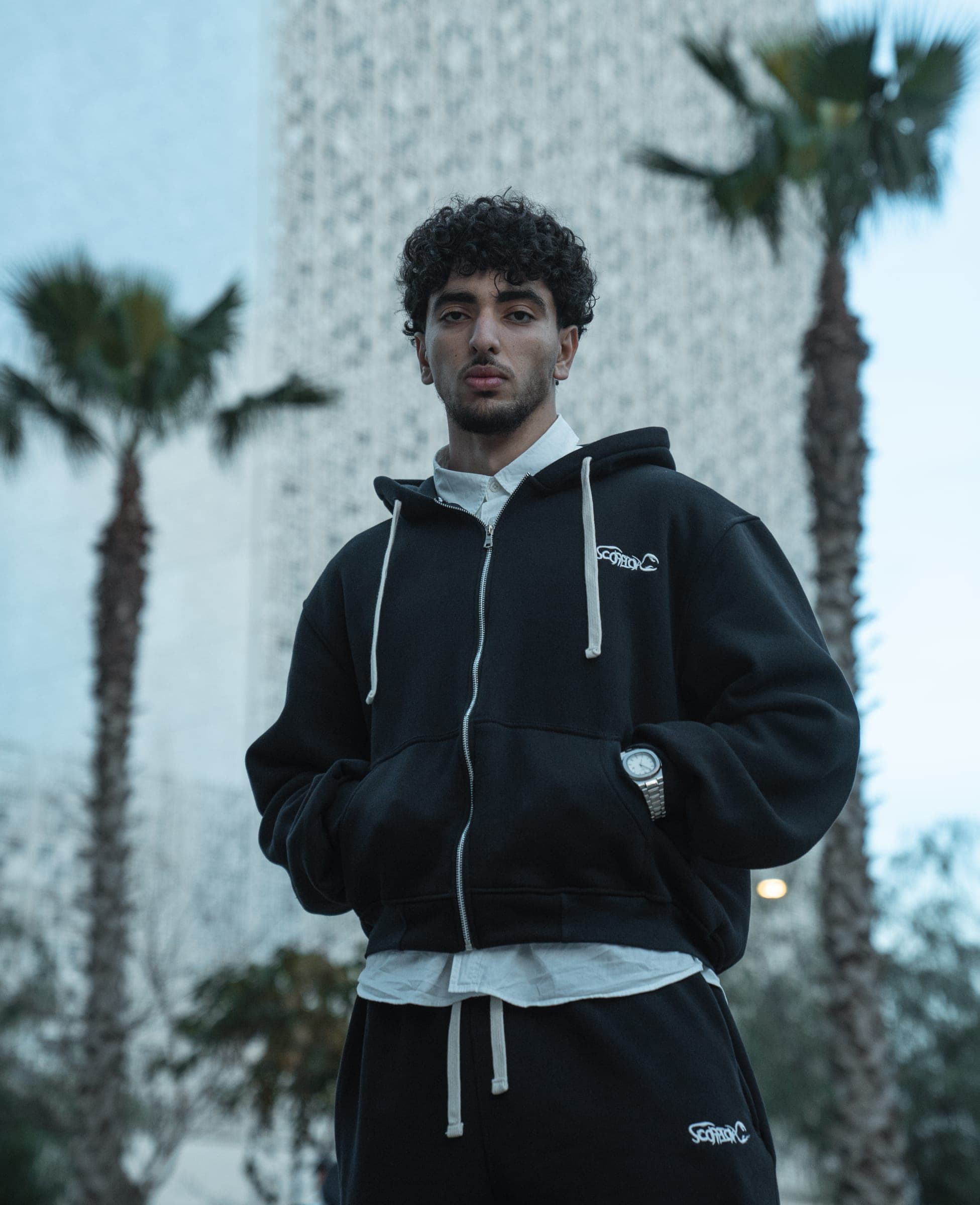 ScorpionX Zip-Up Hoodie worn over a white shirt